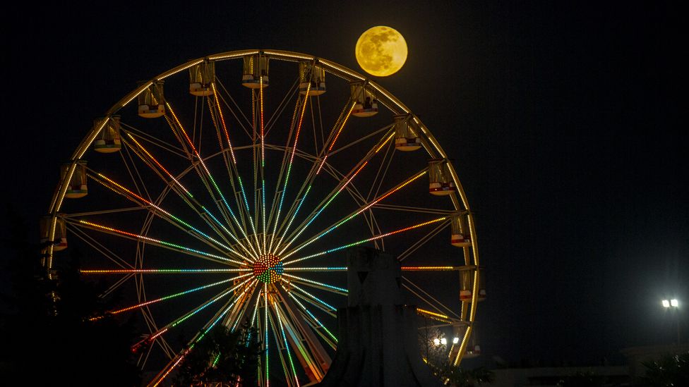 The full moon pictured by a Ferris wheel in Tunis, Tunisia - Friday 5 May 2023