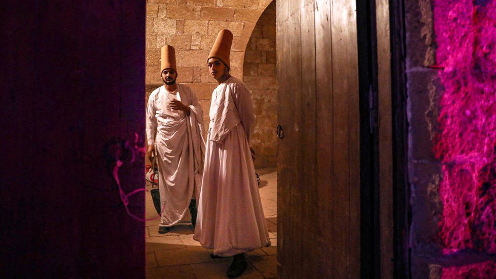 Whirling dervishes prepare to perform at the Amir Taz Palace in Cairo, Egypt on March 27, 2024.