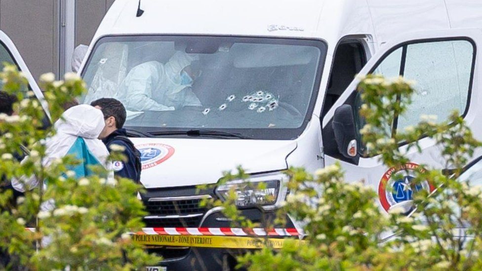 French forensic police inspect a vehicle at the toll station of Incarville, near Rouen, in the North of France, where gunmen ambushed a prison van on 14 May 2024, killing two prison guards and helping a prisoner to escape.