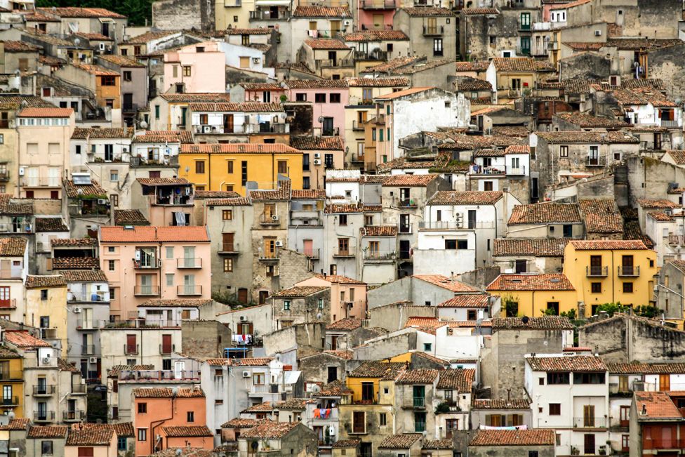Houses built on the steep hillside in Sicily, Italy.