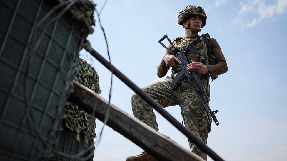 A Ukrainian service member is pictured at a position on the front line