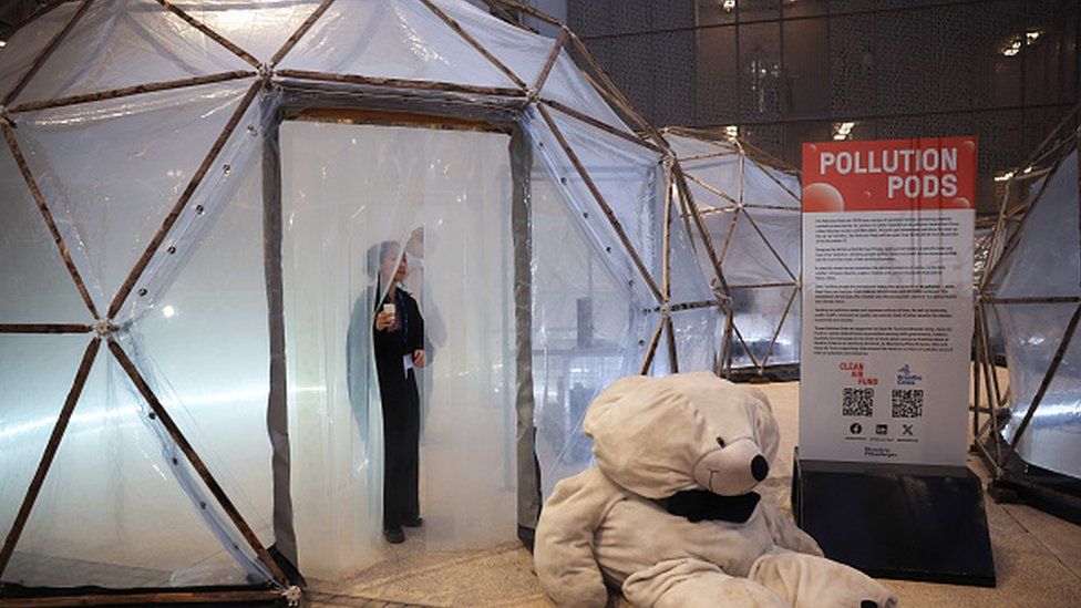 Attendees inside pollution pods, geodesic domes simulating air pollution levels from Beijing, London and New Delhi, on day two of the COP28 climate conference at Expo City in Dubai, United Arab Emirates, on Friday, Dec. 1, 2023