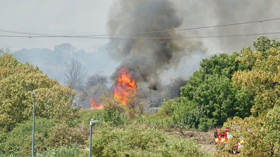 Firefighters attend a fire on Dartford Marshes