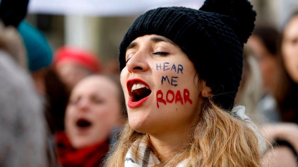 A woman shouts slogans as demonstrators attend the "March4Women" protest on International Women's Day in London, 8 March 2020