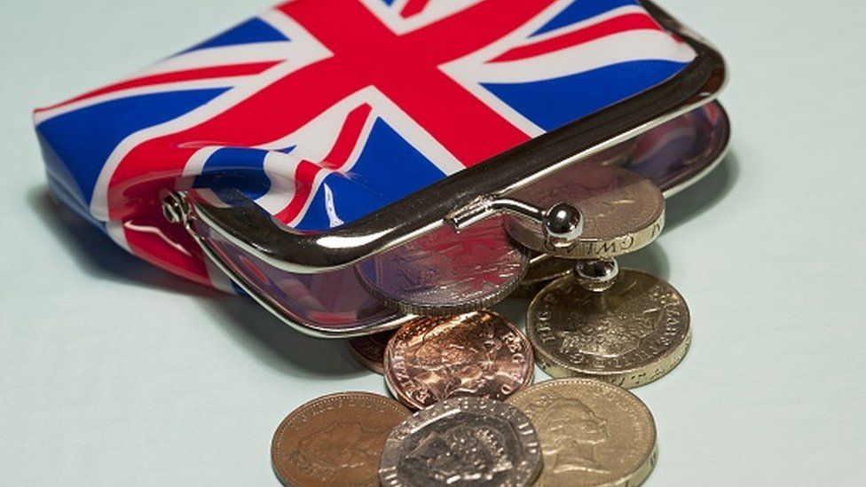 Union Jack purse with coins coming out