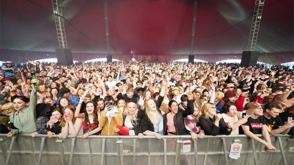 People watch Zuzu perform on stage at a music festival in Sefton Park in Liverpool as part of the national Events Research Programme (ERP)
