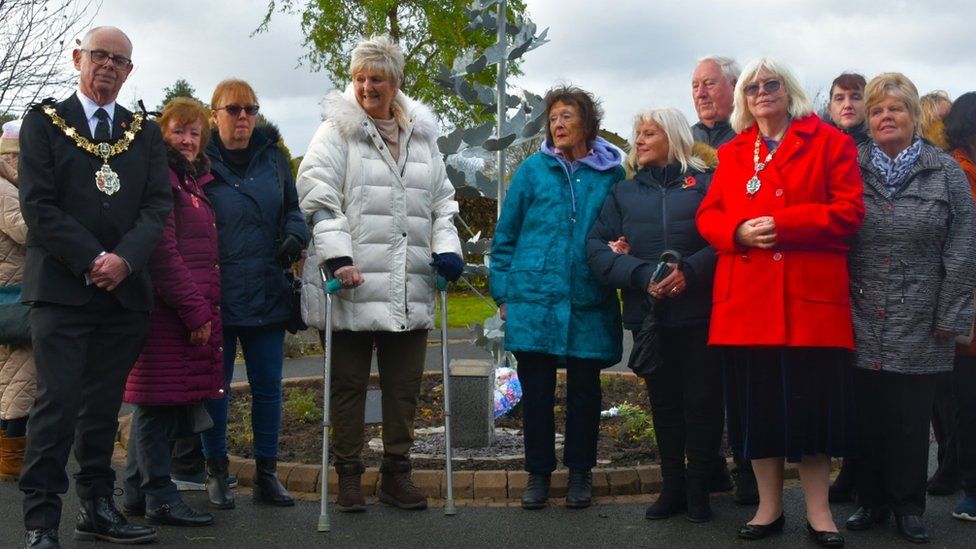 Bereaved families at Landican Cemetery