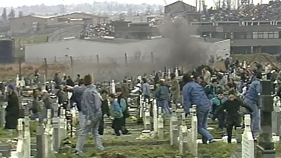 Milltown Cemetery pictured during an attack by loyalist paramilitary Michael Stone