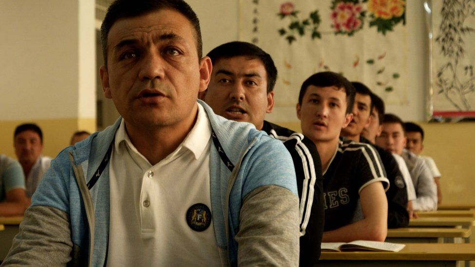 Men sitting in a classroom undergoing lessons in one of Xinjiang's re-education and internment camps
