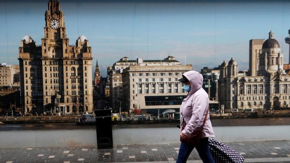 Woman wearing mask walking in Liverpool
