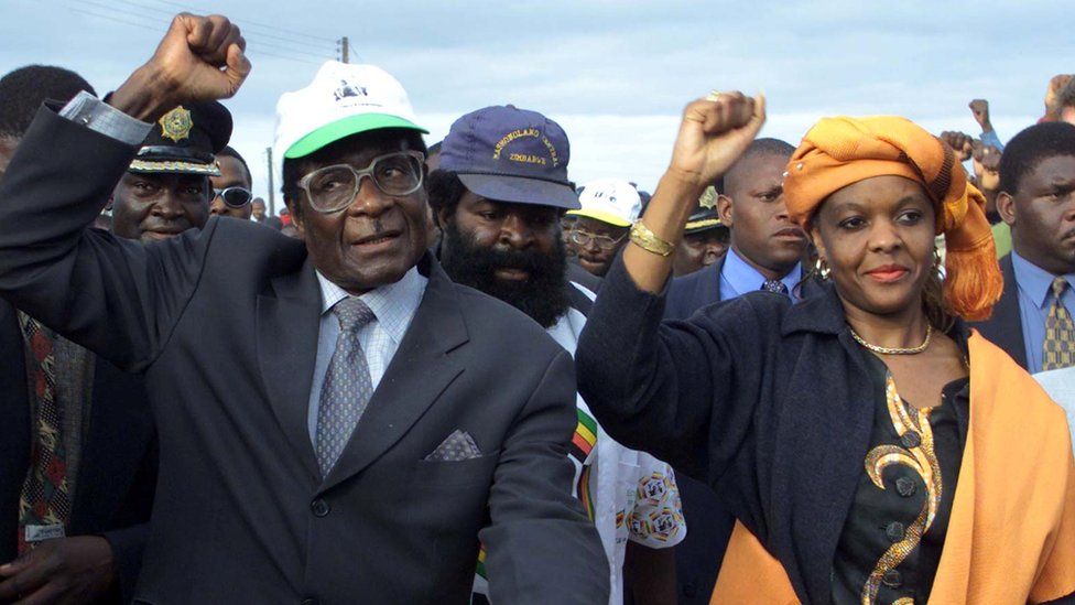 Zimbabwe President Robert Mugabe arrives with his wife Grace for an election rally in Madziwa on 21 June 2000