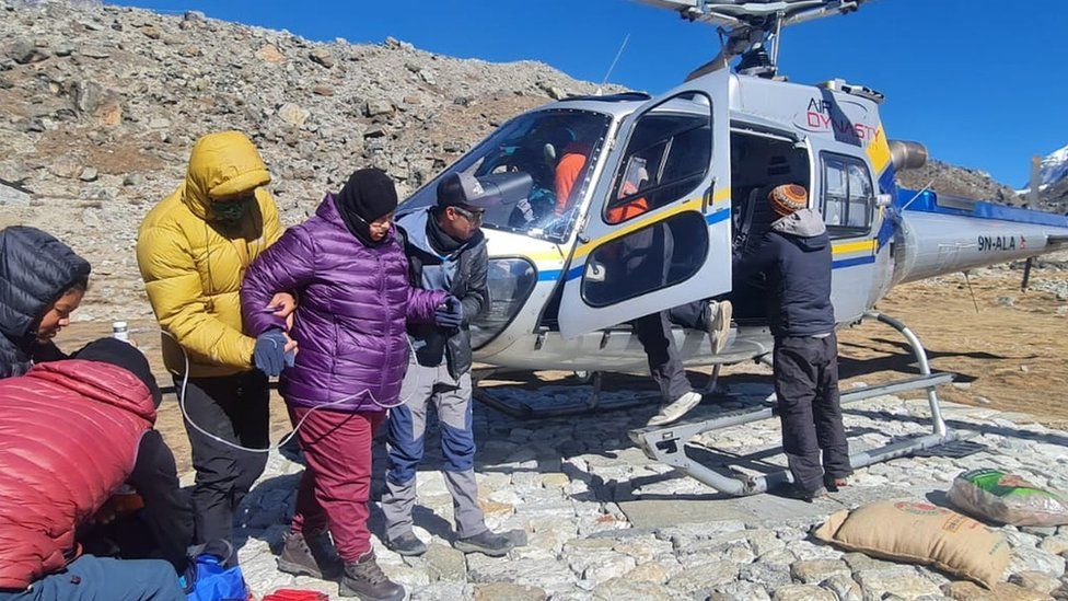 Family on mountain with helicopter
