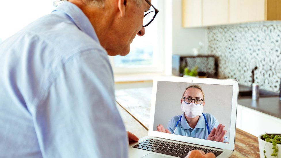 Video conference call with nurse, posed by models