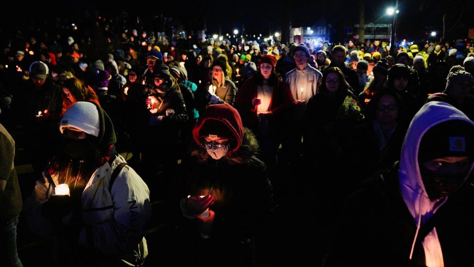 People gather at a candlelight vigil in Waukesha