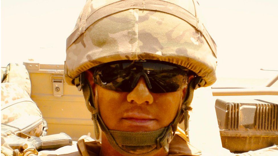 James Dieterle in his army uniform wearing sunglasses and a helmet