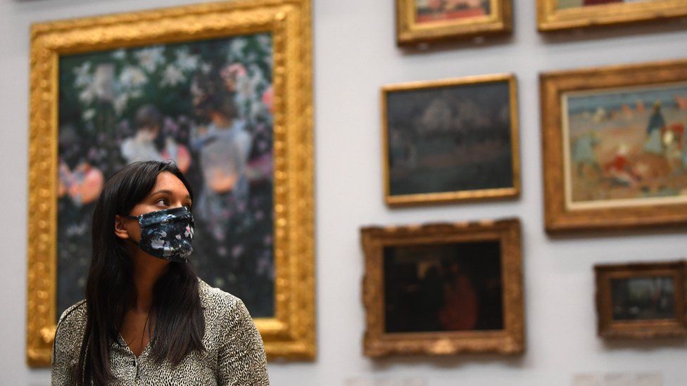 Gallery worker in face covering poses at Tate Britain ahead of its reopening