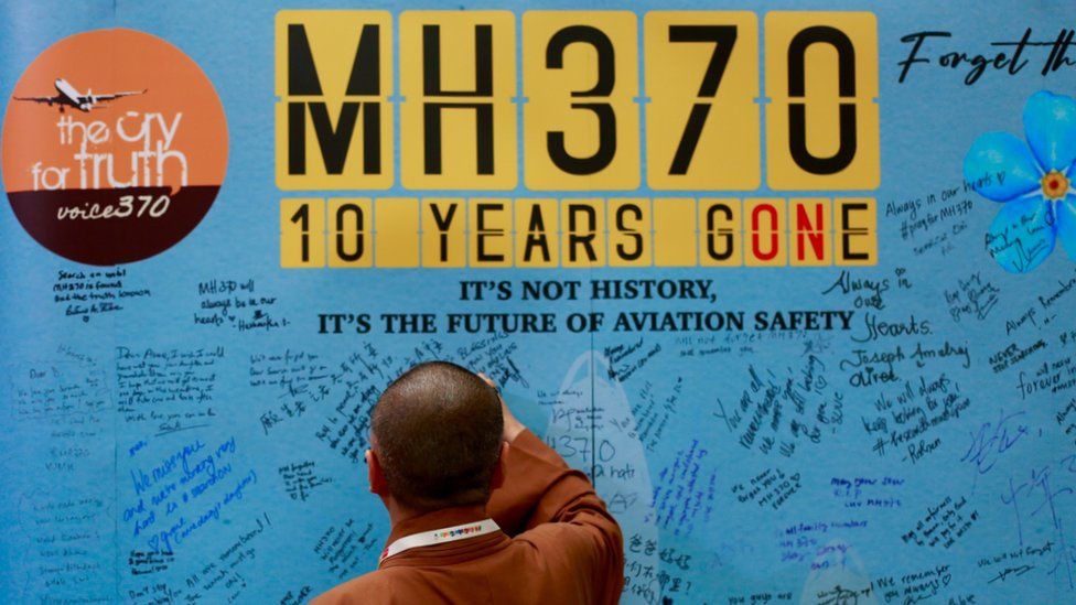 A man writing messages at the Day of Remembrance for MH370 in Petaling Jaya, Malaysia, on 3 March, 2024.