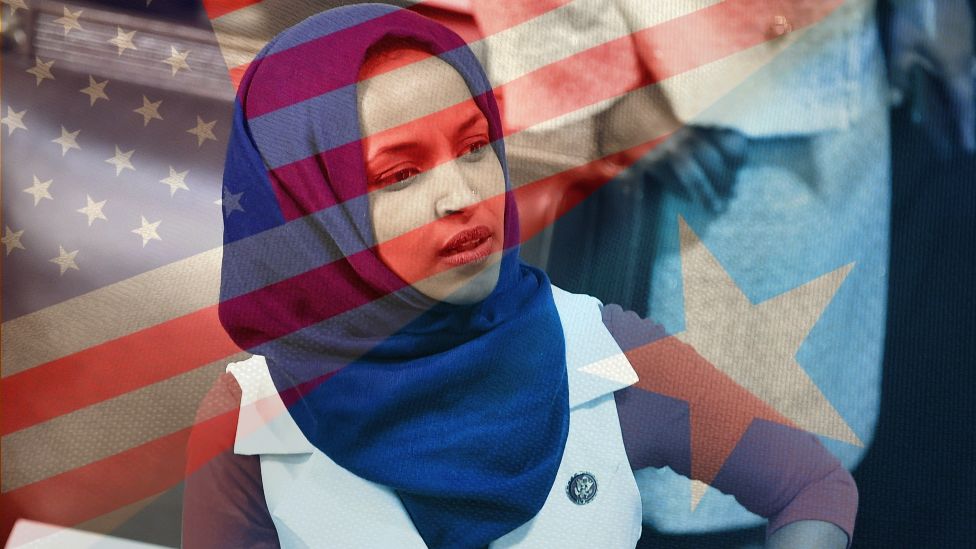 Ilhan Omar with the backdrop of the US and Somali flags