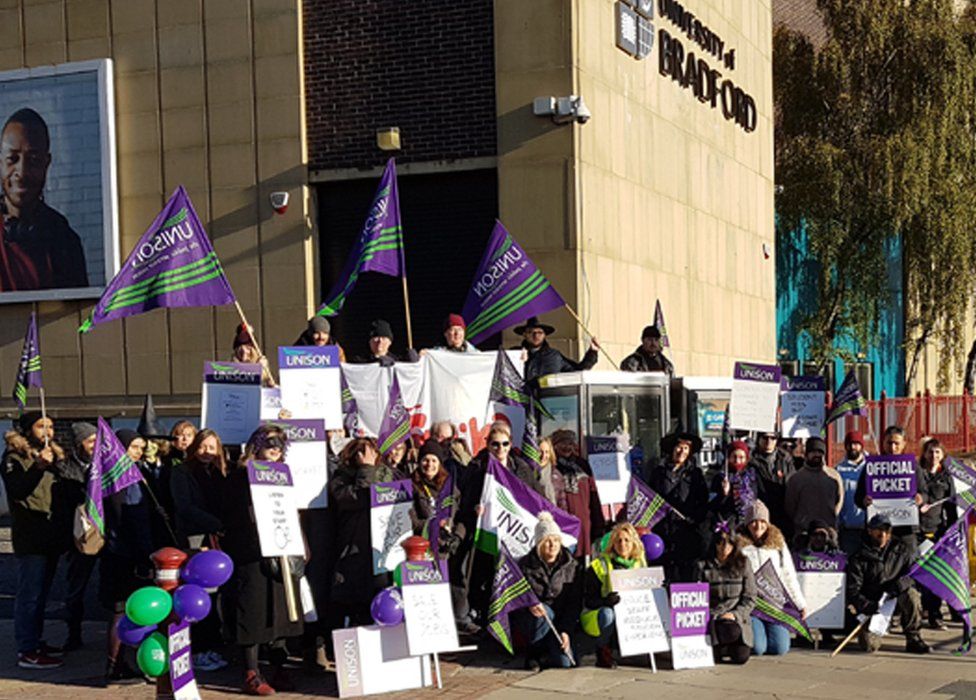 People with placards outside the University of Bradford