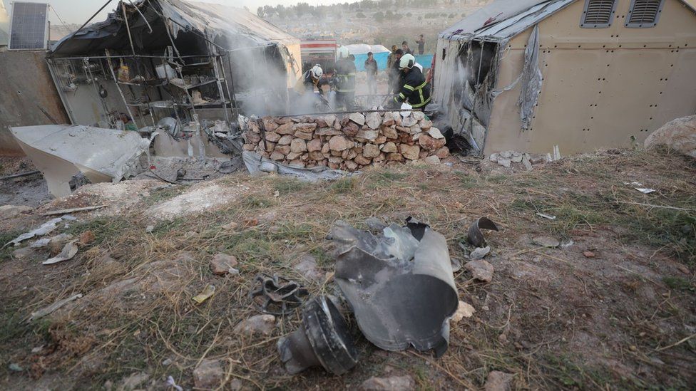 Firemen put out a blaze after a reported rocket strike on Maram camp for displaced people in Idlib province, Syria (6 November 2022)