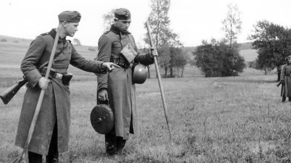 German soldiers inspect a minefield