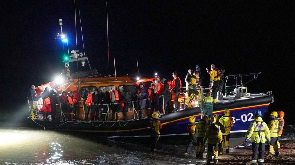 A group of people thought to be migrants are brought into Dungeness, Kent