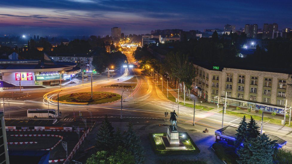 Moldova, Chisinau, Cityscape illuminated at dusk