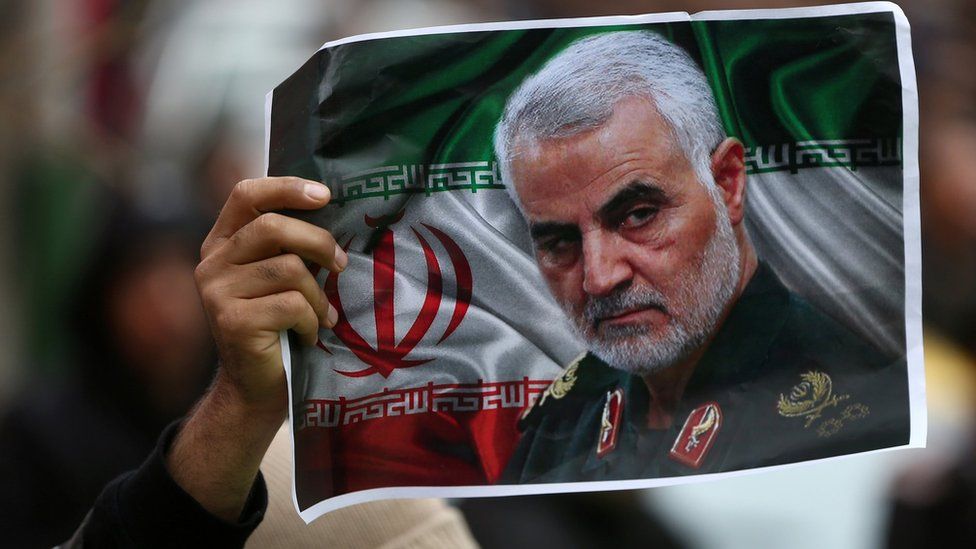 An Iranian holds up a picture of Qasem Soleimani in Tehran, Iran, on 4 January 2020