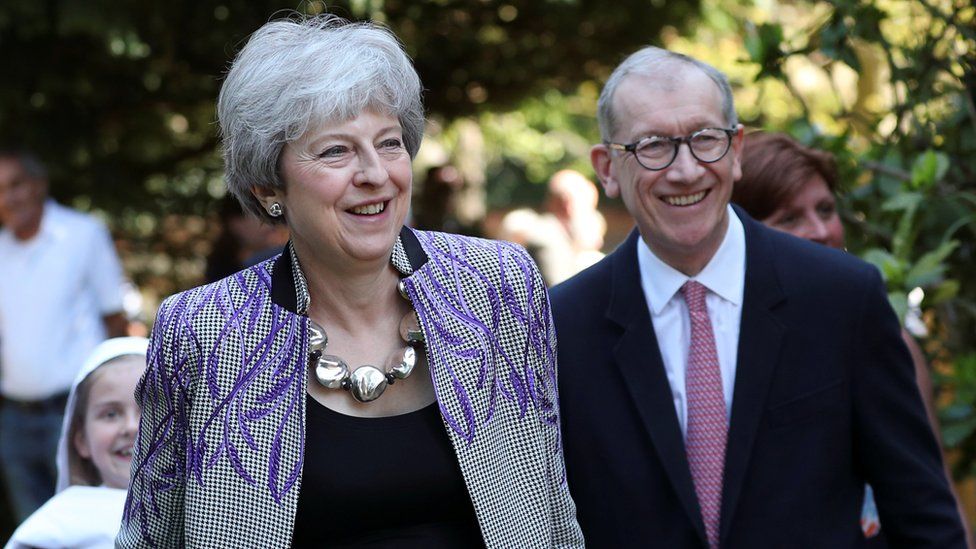 Theresa May and her husband Philip leaving a local church