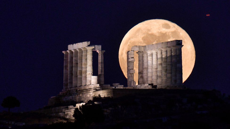 The Moon rises behind the ancient Temple of Poseidon near Athens, Greece. Photo: 26 May 2021