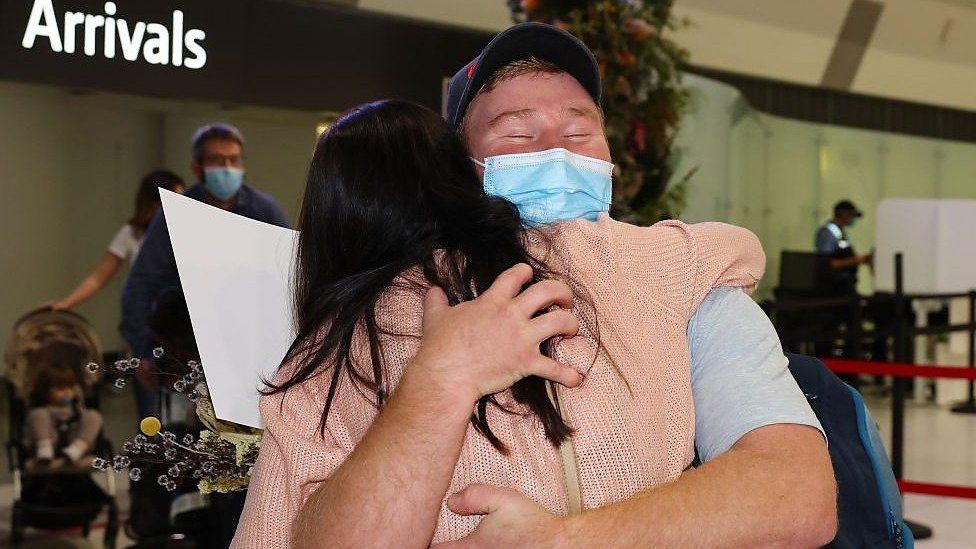 Man and woman hugging at Perth airport