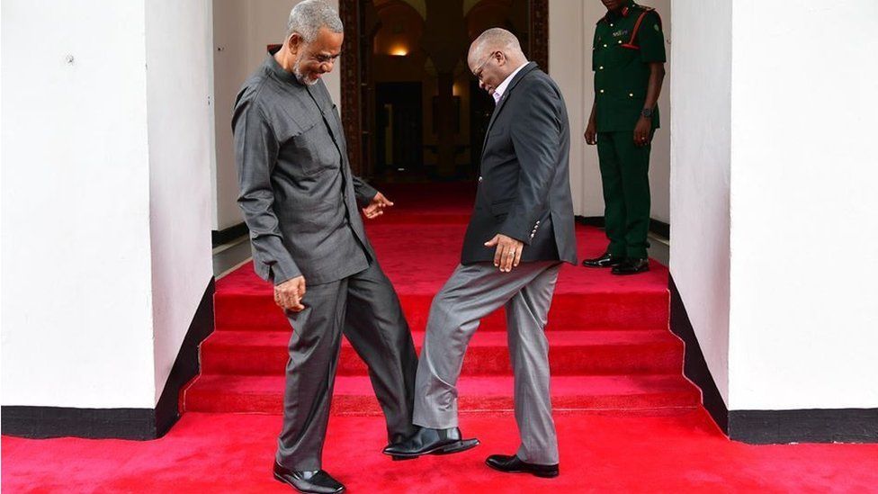 Tanzanian opposition politician Maalim Seif Sharif Hamad (L) by tapping his feet against theirs to avoid themselves from coronavirus in Zanzibar, Tanzania on March 03, 2020.