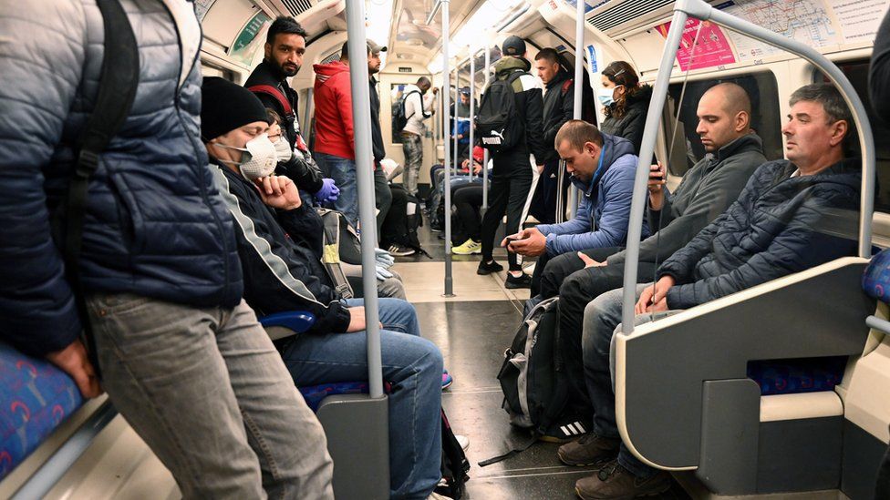 People travel on an underground train, on the Jubilee Line, in L
