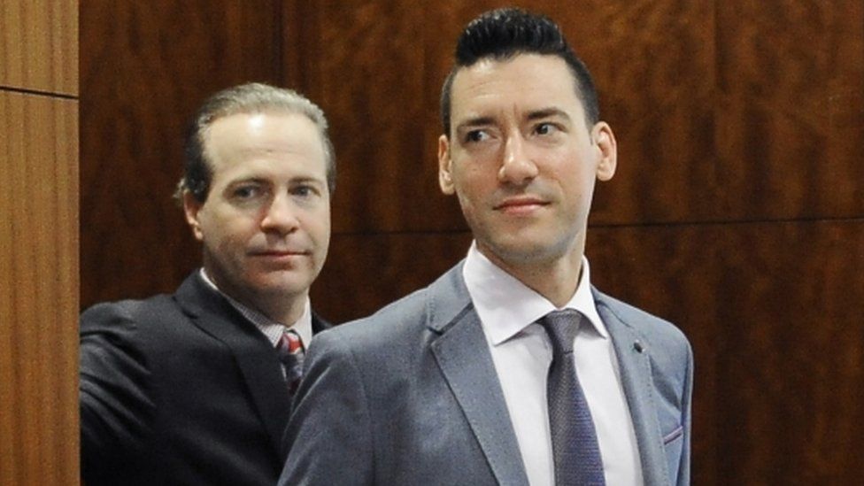 David Robert Daleiden, right, leaves a courtroom after a hearing in Houston.