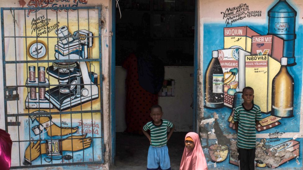 Children outside a pharmacy in Mogadishu, Somalia - 2016