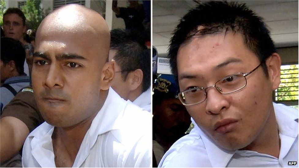 Myuran Sukumaran (L) and Andrew Chan (R) being escorted out of a court in Denpasar, on Bali island, 14 February 2006
