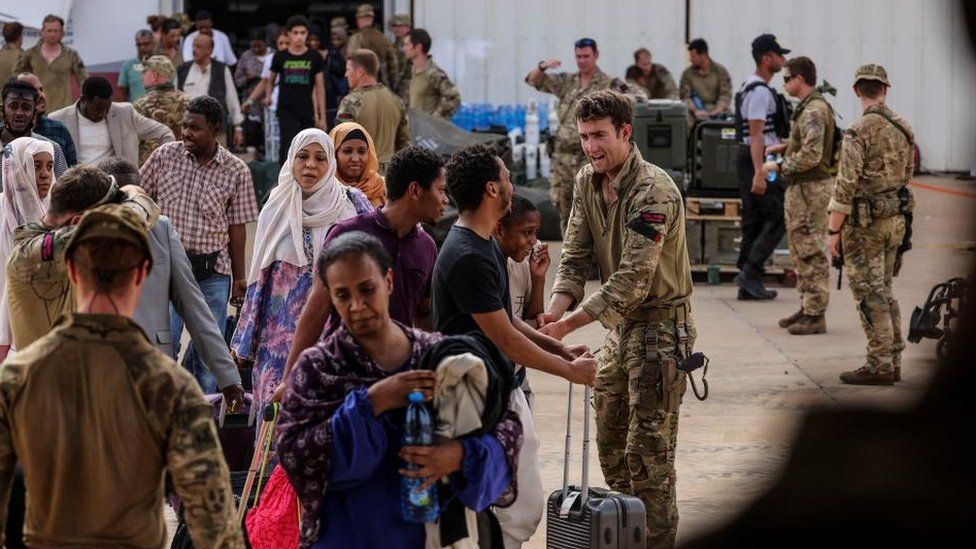 British nationals make their way onto an awaiting RAF aircraft, during the evacuation to Cyprus, at Wadi Seidna Air Base in Sudan April 27, 2023.