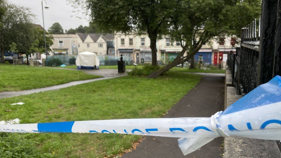 A police cordon and a forensic scene tent in a park in Bristol