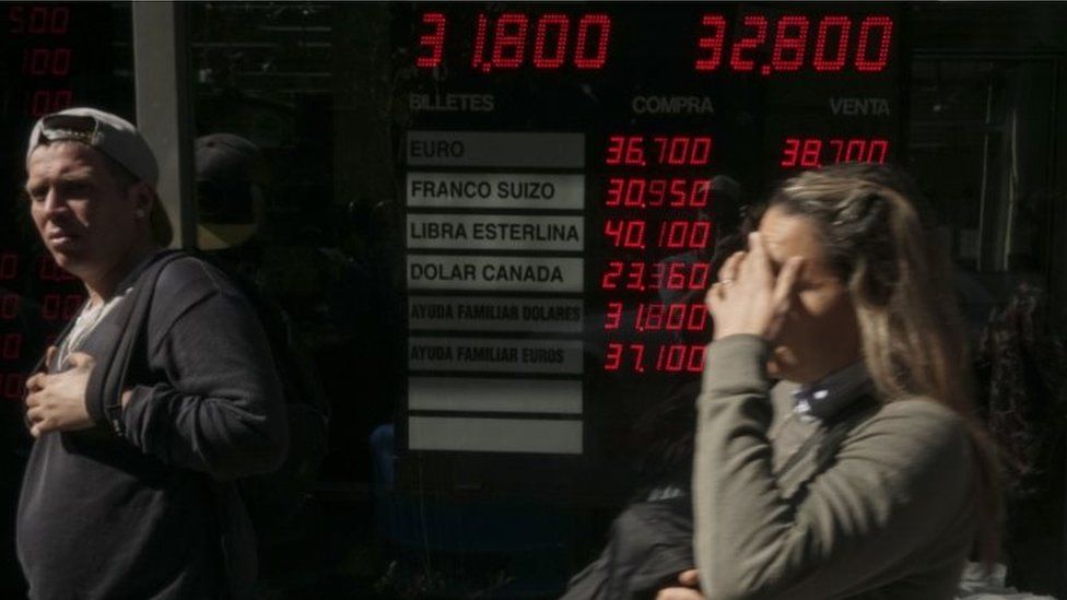 Currency exchange values are displayed in the buy-sell board of a bureau de exchange in Buenos Aires, on August 29, 2018.