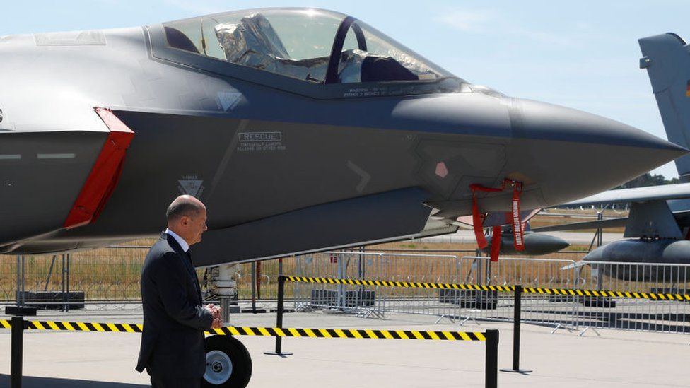 The German chancellor alongside a US F35 fighter jet earlier this year