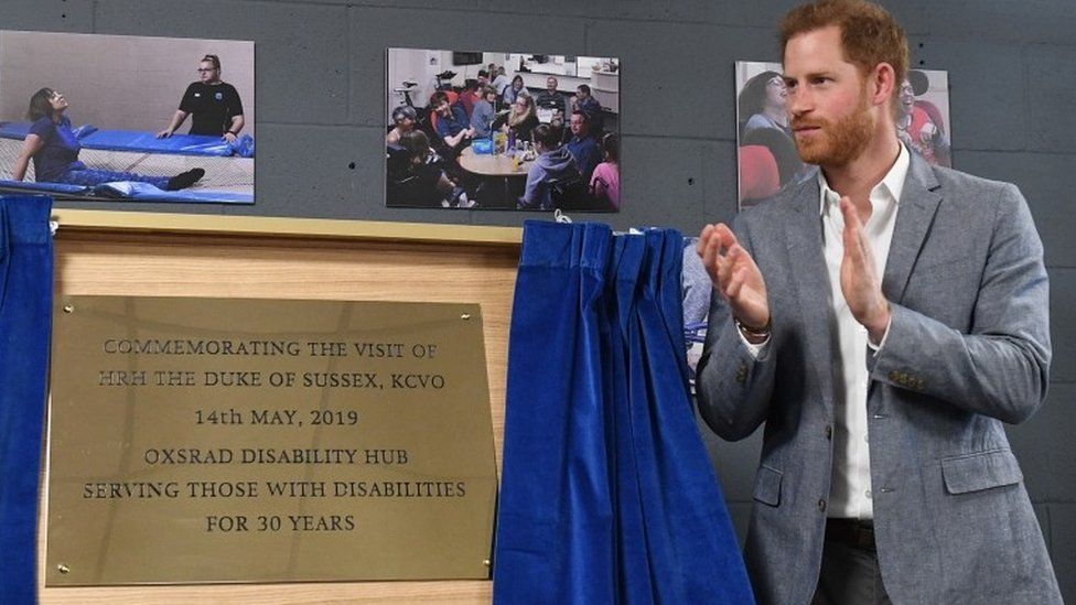 Prince Harry unveils a plaque commemorating his visit to the OXSRAD Disability Sports and Leisure Centre
