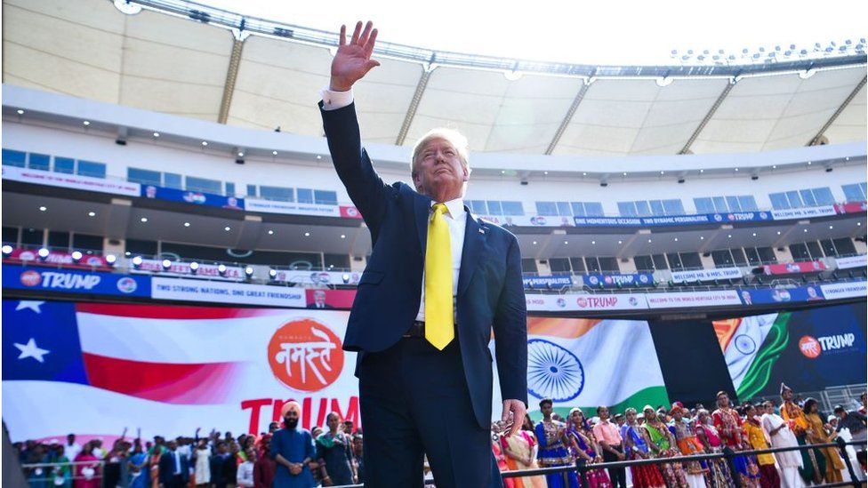 Mr Trump waving at crowds