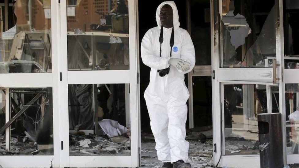 A forensic police officer exits the Splendid Hotel after al Qaeda militants killed at least 28 people from at least seven countries in an attack on the hotel and a restaurant in Ouagadougou, Burkina Faso, January 18, 2016.