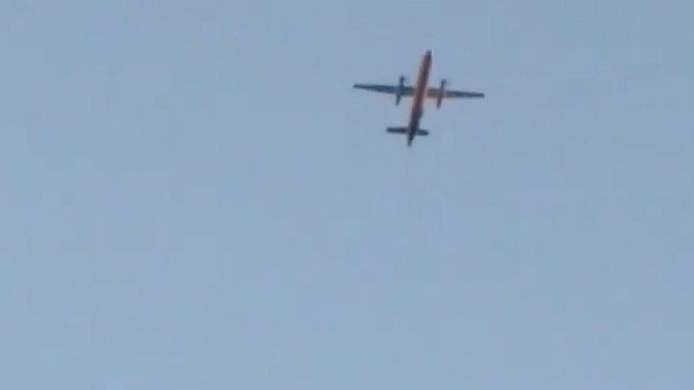 A Horizon Air Bombardier Dash 8 Q400, reported to be hijacked, flies over Fircrest, Washington, the U.S., before crashing in the South Puget Sound,