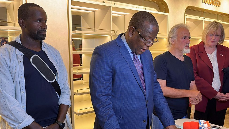 French journalist Olivier Dubois and US aid worker Jeffery Woodke listening to Niger Interior Minister Hamadou Adamou Souley after they were released in Niamey, Niger