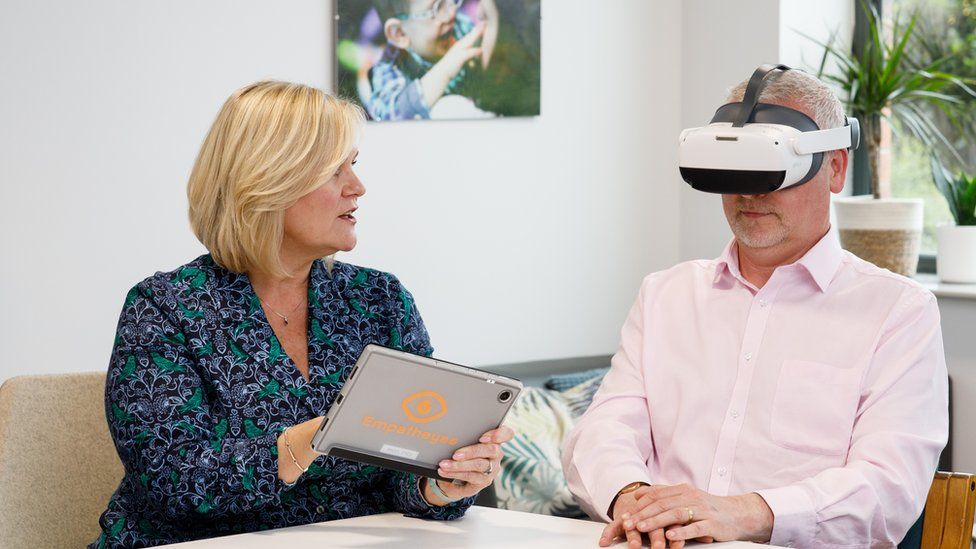 Sara McCracken speaks to Stephen Ellis from the Innovation Factory as he uses a VR headset