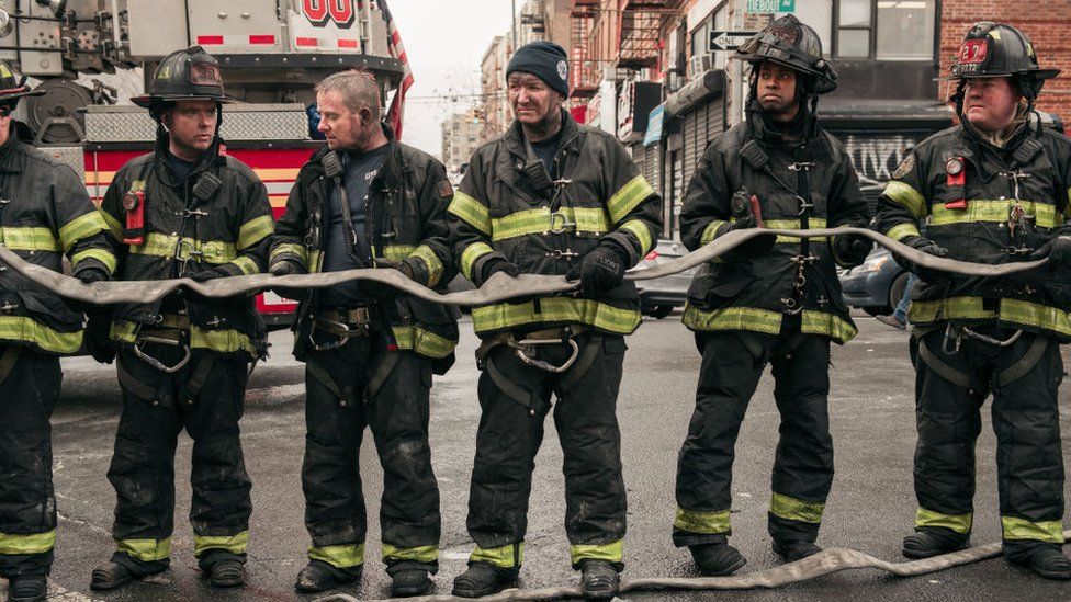 Firefighters at the scene of a apartment block fire in New York