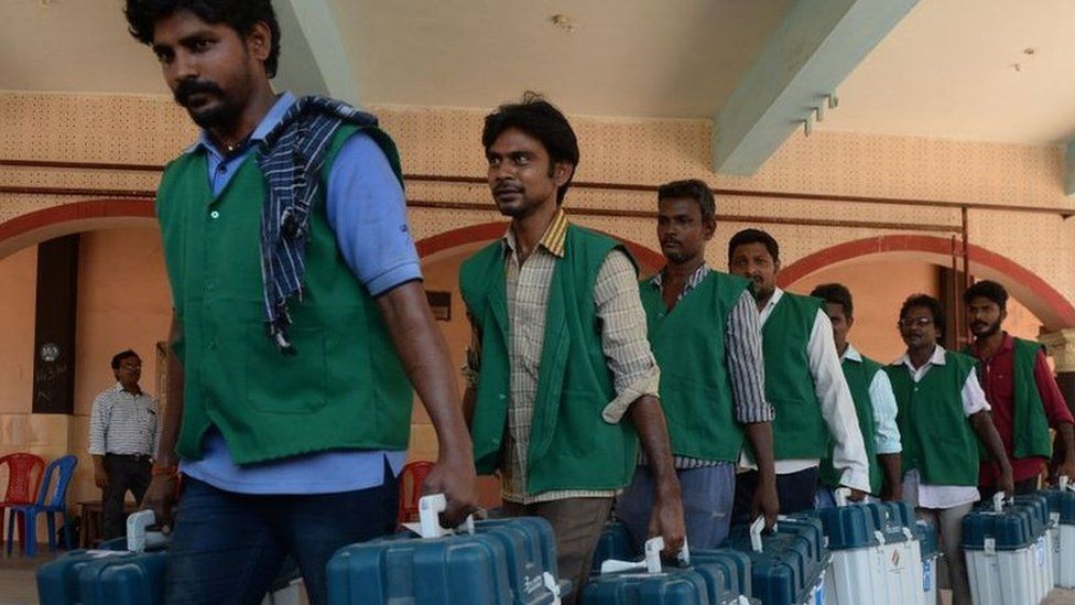 Indian election workers carry boxes containing Electronic Voting Machines (EVM) at a distribution point in Chennai on April 17, 2019, ahead of the second phase of India's general election.