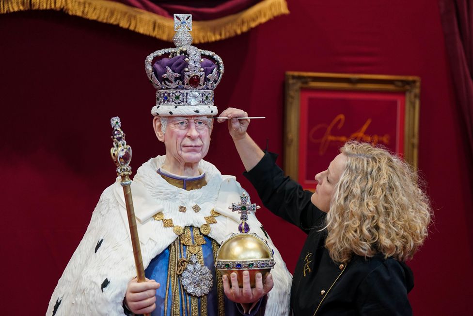 The finishing touches are applied to a life size cake figure of King Charles III by sugar artist Emma Jayne