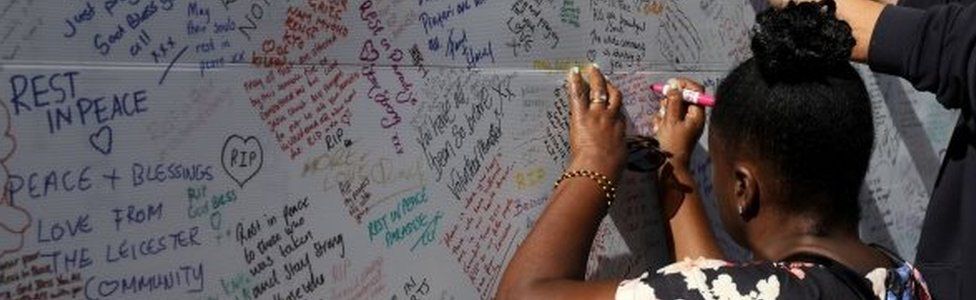 A woman writing a message of condolence